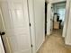 Hallway featuring white doors, neutral colored carpet, and views into other rooms at 5347 Ocarol Ct, Stone Mountain, GA 30088