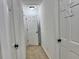 Hallway featuring white doors, neutral colored carpet, and dark door hardware at 5347 Ocarol Ct, Stone Mountain, GA 30088