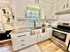Bright kitchen with stainless steel appliances, granite countertops, and white cabinets at 5347 Ocarol Ct, Stone Mountain, GA 30088