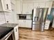 Bright kitchen with stainless steel appliances, granite countertops, and white cabinets at 5347 Ocarol Ct, Stone Mountain, GA 30088