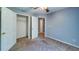 A bedroom with neutral walls, plush carpet, and an adjoining closet at 2161 Denson Sw Ln, Marietta, GA 30008