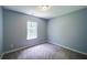 This carpeted bedroom has a standard closet and a window for natural light at 2161 Denson Sw Ln, Marietta, GA 30008
