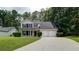 Charming two-story home featuring a well-manicured lawn and a two-car garage at 2161 Denson Sw Ln, Marietta, GA 30008