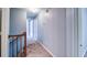 Upstairs hallway with neutral carpet and paint leading to multiple rooms at 2161 Denson Sw Ln, Marietta, GA 30008
