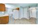 Traditional kitchen with upper cabinets and appliances, adjacent to hall and back door at 2161 Denson Sw Ln, Marietta, GA 30008