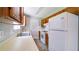 Charming kitchen featuring white countertops, wood cabinets, and white appliances at 2161 Denson Sw Ln, Marietta, GA 30008