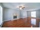 Bright living room featuring hardwood floors, a ceiling fan, and a fireplace at 2161 Denson Sw Ln, Marietta, GA 30008