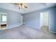 Large main bedroom featuring vaulted ceilings, neutral carpet, and access to a walk-in closet at 2161 Denson Sw Ln, Marietta, GA 30008