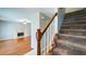 Carpeted staircase with wooden banister, flowing into a living room with a fireplace at 2161 Denson Sw Ln, Marietta, GA 30008
