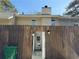 Back gate with an open view to the house with a garbage bin at 4383 Idlewood Ln, Tucker, GA 30084
