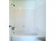 Bright bathroom featuring a white tiled shower and tub combination at 4383 Idlewood Ln, Tucker, GA 30084