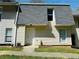 Exterior view of a two-story home with neutral siding, gray roof, tidy landscaping, and a white front door at 4383 Idlewood Ln, Tucker, GA 30084