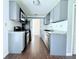 Functional kitchen with stainless steel appliances, gray cabinets, and wood-look floors for a modern touch at 4383 Idlewood Ln, Tucker, GA 30084