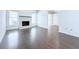 Bright living room with dark wood floors, a white brick fireplace, and multiple windows for natural light at 4383 Idlewood Ln, Tucker, GA 30084