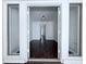 Charming entry view through a large window into a neutral living room with dark wood floors at 4383 Idlewood Ln, Tucker, GA 30084
