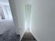 Carpeted staircase leading to the lower level, illuminated by a pendant light at 4383 Idlewood Ln, Tucker, GA 30084
