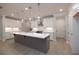 Spacious kitchen with island, white countertops, stainless steel range hood, and pendant lighting at 510 Winston Croft Cir # 56, Johns Creek, GA 30022