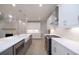 Kitchen area features stainless steel appliances, island, and quartz countertops at 510 Winston Croft Cir # 56, Johns Creek, GA 30022