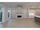 Sunlit living area featuring a stone fireplace, sliding glass doors, and an open layout to the kitchen at 510 Winston Croft Cir # 56, Johns Creek, GA 30022