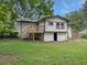 Exterior view of a two-story home with a spacious backyard and wooden deck at 5207 White Sw Blvd, Mableton, GA 30126