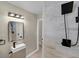 Modern bathroom featuring a sleek vanity, stylish mirror, and tiled shower at 5207 White Sw Blvd, Mableton, GA 30126