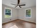 Bedroom with large window offering natural light, and laminate flooring at 5207 White Sw Blvd, Mableton, GA 30126