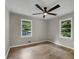 Bedroom with large windows offering natural light, and laminate flooring at 5207 White Sw Blvd, Mableton, GA 30126