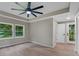 Bedroom with large windows offering natural light, tray ceiling and laminate flooring at 5207 White Sw Blvd, Mableton, GA 30126