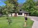 Landscaped front yard leading to a charming single-story home with painted brick at 5207 White Sw Blvd, Mableton, GA 30126
