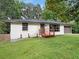 Charming single-story home showcasing a well-maintained lawn and a cozy front porch at 5207 White Sw Blvd, Mableton, GA 30126