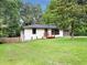 Single-story home with painted brick, a cozy front porch, and a well-maintained lawn at 5207 White Sw Blvd, Mableton, GA 30126