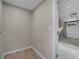 Hallway to the garage with door on right and concrete floor garage at 5207 White Sw Blvd, Mableton, GA 30126