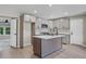 Well-lit kitchen featuring a large island, stainless steel appliances, and sleek cabinets at 5207 White Sw Blvd, Mableton, GA 30126