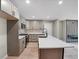 Modern kitchen boasts light-colored cabinetry, quartz countertops, and a large center island with an undermount sink at 5207 White Sw Blvd, Mableton, GA 30126