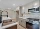 Kitchen featuring stainless steel appliances, ample cabinet space, and a stylish sink at 5207 White Sw Blvd, Mableton, GA 30126