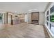 Open concept living area with a modern fireplace, island, and hardwood floors at 5207 White Sw Blvd, Mableton, GA 30126