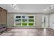 Bright living room featuring large windows, hardwood floors and modern fireplace at 5207 White Sw Blvd, Mableton, GA 30126