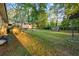 Expansive backyard featuring mature trees and a basketball hoop for recreation and entertainment at 761 Robert E Lee Pkwy, Jonesboro, GA 30238