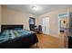 Cozy bedroom with hardwood floors, a comfortable bed, and a bright, airy atmosphere at 761 Robert E Lee Pkwy, Jonesboro, GA 30238