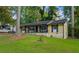 Well-kept home exterior featuring mature trees and a lush green lawn at 761 Robert E Lee Pkwy, Jonesboro, GA 30238