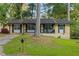 Charming single-story home with a well-maintained lawn, traditional windows and black shutters at 761 Robert E Lee Pkwy, Jonesboro, GA 30238