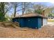 Back view of the blue brick home with a wooden wheelchair ramp in the backyard at 1089 Indale Sw Pl, Atlanta, GA 30310