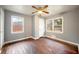 Cozy bedroom featuring a ceiling fan, natural light, and beautiful hardwood floors at 1089 Indale Sw Pl, Atlanta, GA 30310