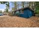 Side view of blue brick home with a wheelchair ramp surrounded by fallen leaves at 1089 Indale Sw Pl, Atlanta, GA 30310