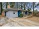 Side view of blue brick home with a wheelchair ramp and concrete driveway at 1089 Indale Sw Pl, Atlanta, GA 30310