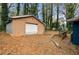 View of the detached garage in the backyard with a white door and fallen leaves at 1089 Indale Sw Pl, Atlanta, GA 30310