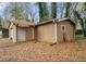 Exterior view of detached garage with tan wood paneling in the backyard at 1089 Indale Sw Pl, Atlanta, GA 30310