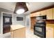 This kitchen features tile floors, wood cabinets, and brick backsplash at 1089 Indale Sw Pl, Atlanta, GA 30310