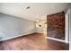 Inviting living room featuring beautiful hardwood floors and a unique brick accent wall at 1089 Indale Sw Pl, Atlanta, GA 30310