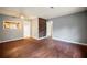 Spacious living room featuring hardwood floors, an exposed brick wall, and neutral paint at 1089 Indale Sw Pl, Atlanta, GA 30310